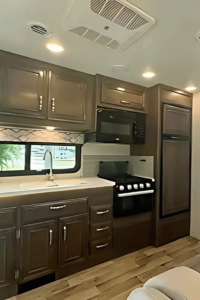 A galley kitchen with lots of storage and appliances.