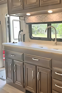 A large sink with under cabinet lighting.